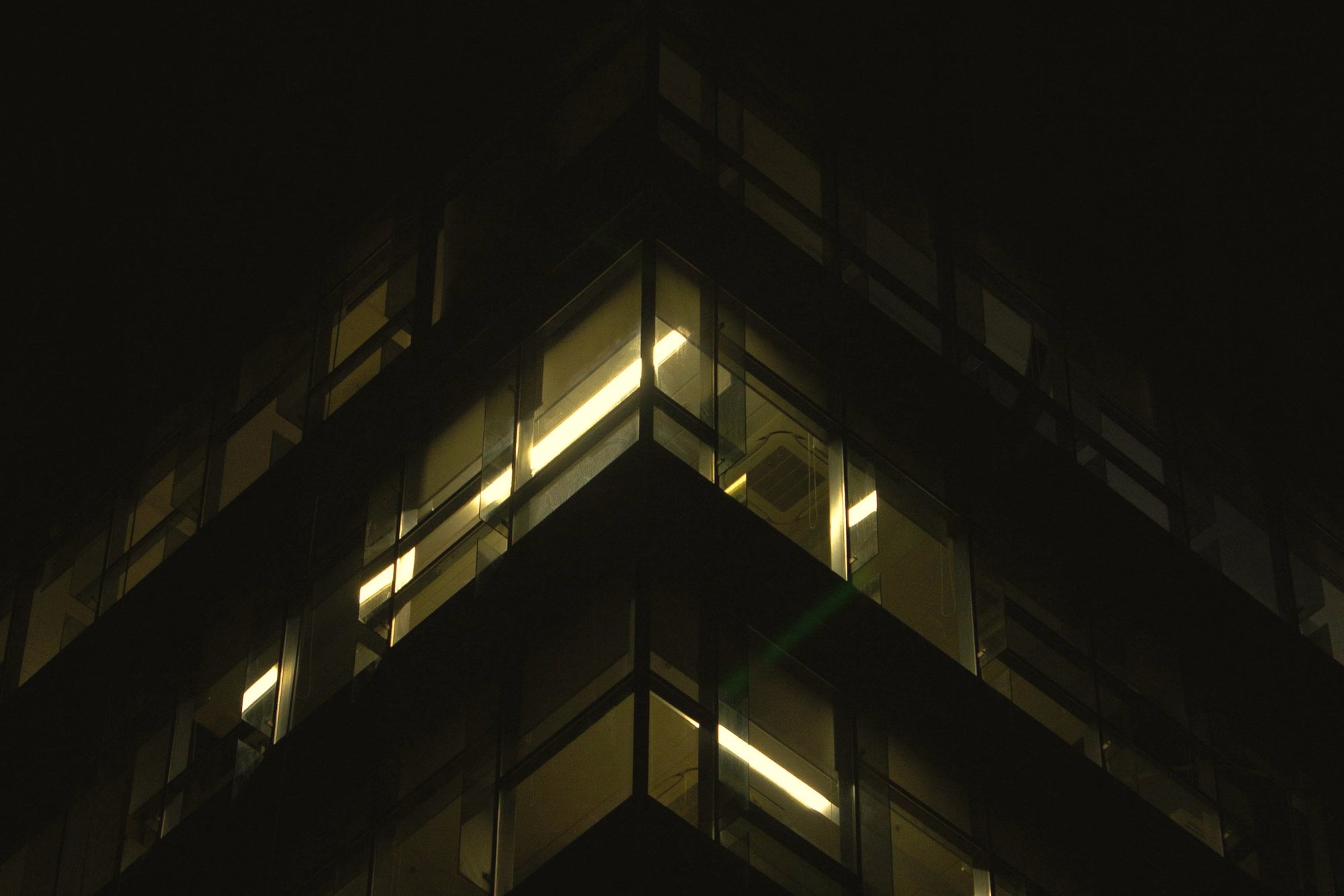 The lit corner of an office building at night