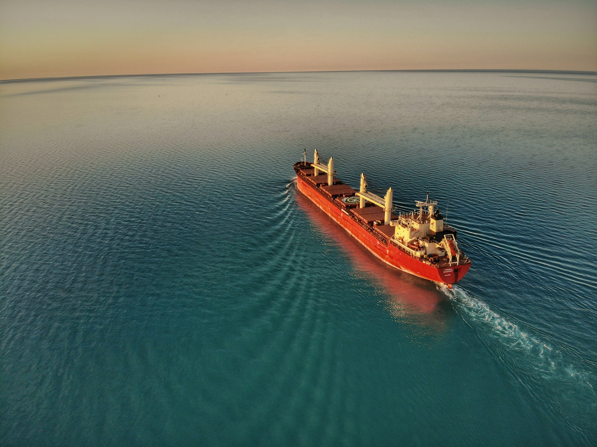 A cargo ship at sea from above