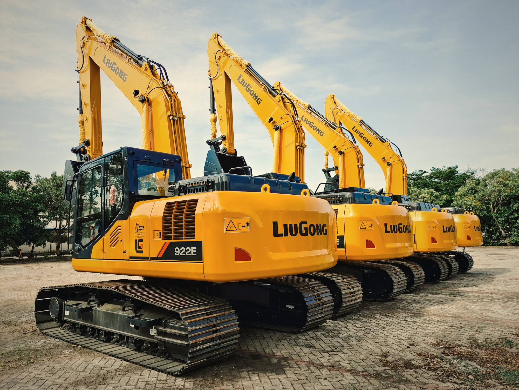 A row of yellow excavators