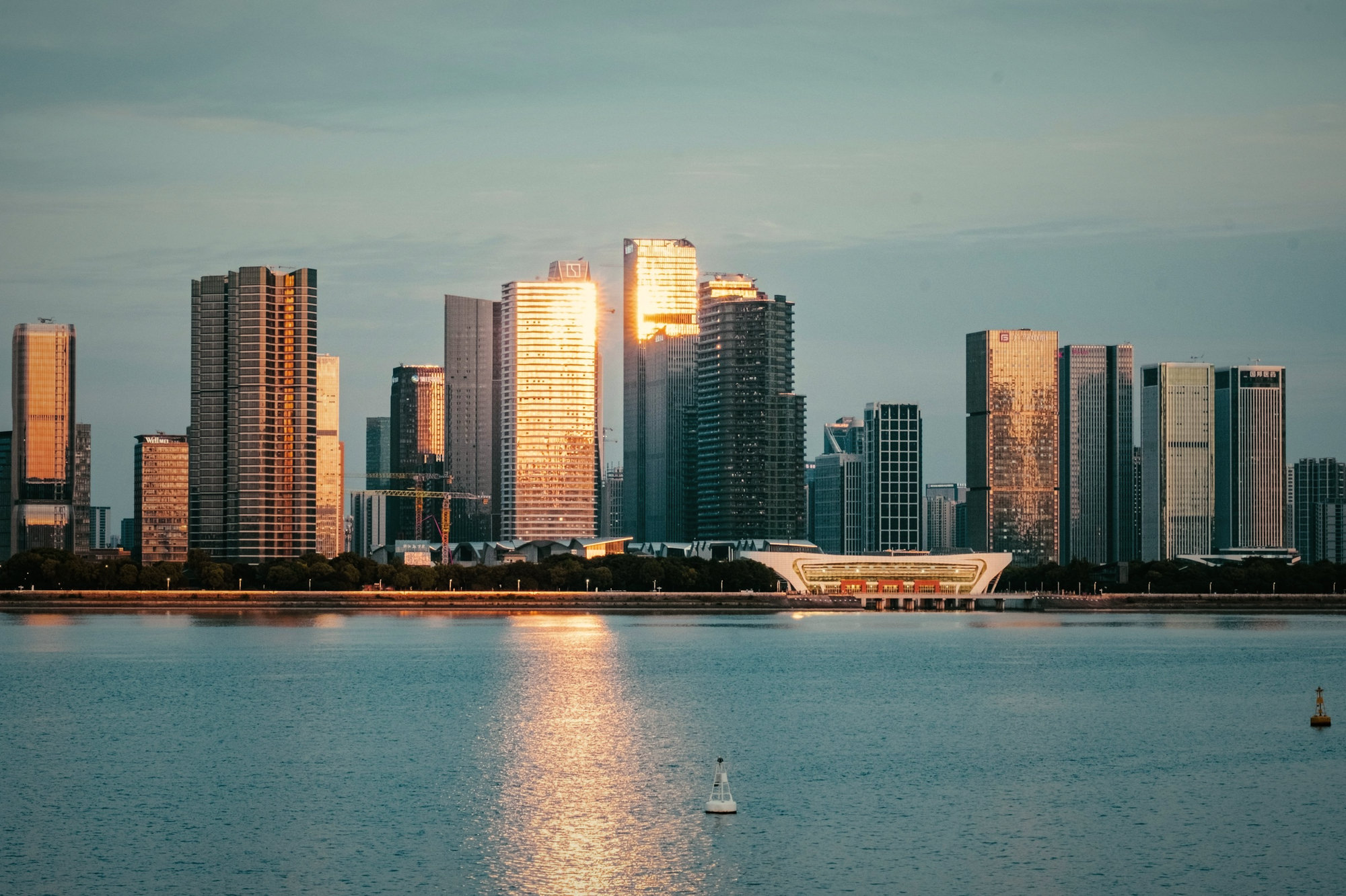 Skyscrapers over water at dusk